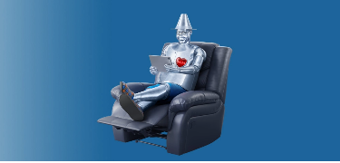Man made of tin sitting in a recliner.